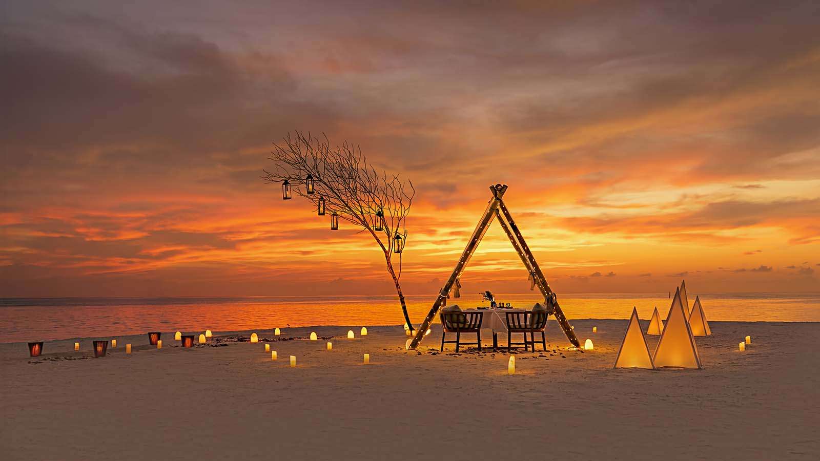 a private dining at sunset on the beach at Nala Maldives adults only resort