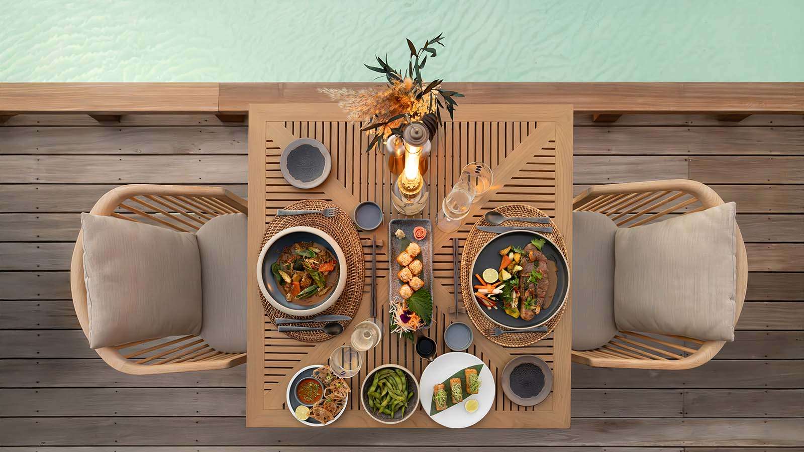 Dining set for two on the deck at Kumo Restaurant, Nala Maldives