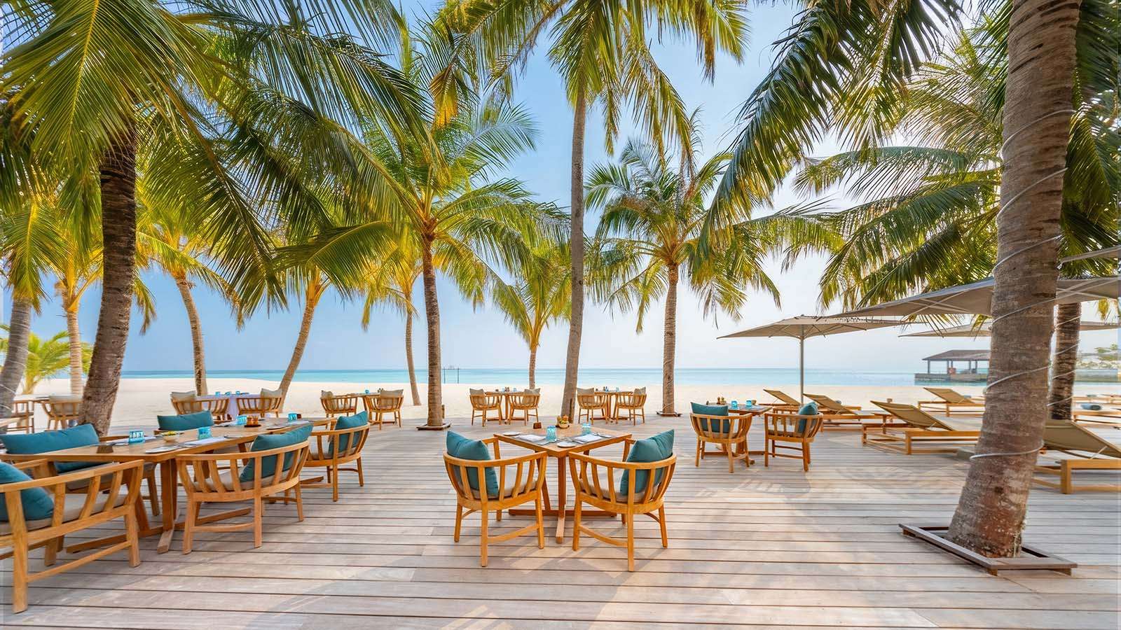 The outside terrace under palm trees Velu buffet restaurant at nala Maldives, adults Only resort