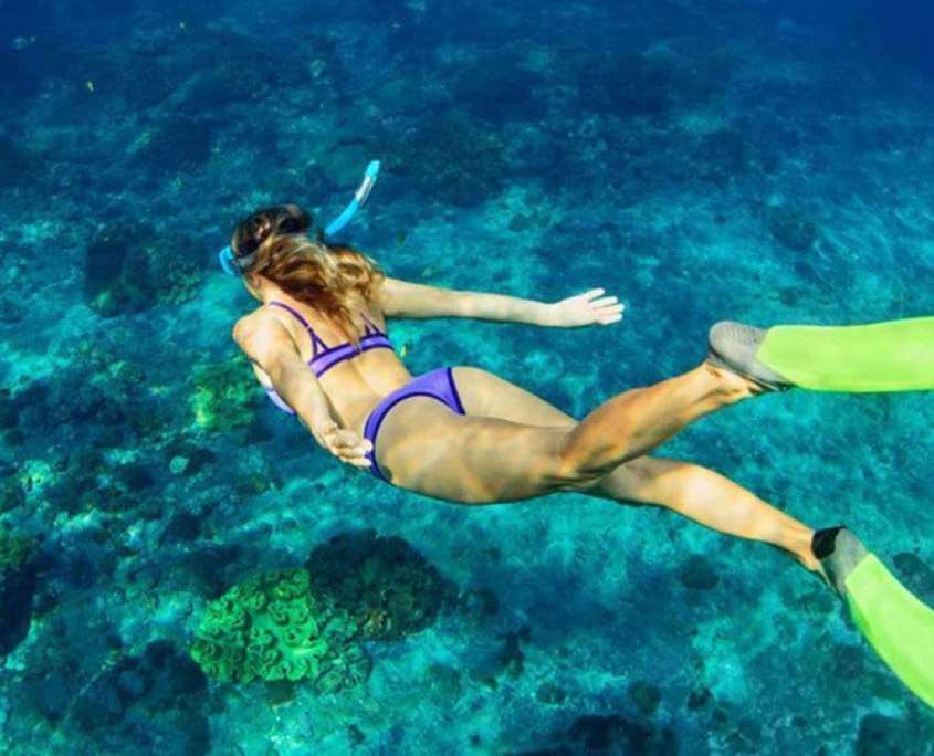 A woman snorkelling in The Maldives with Prodivers