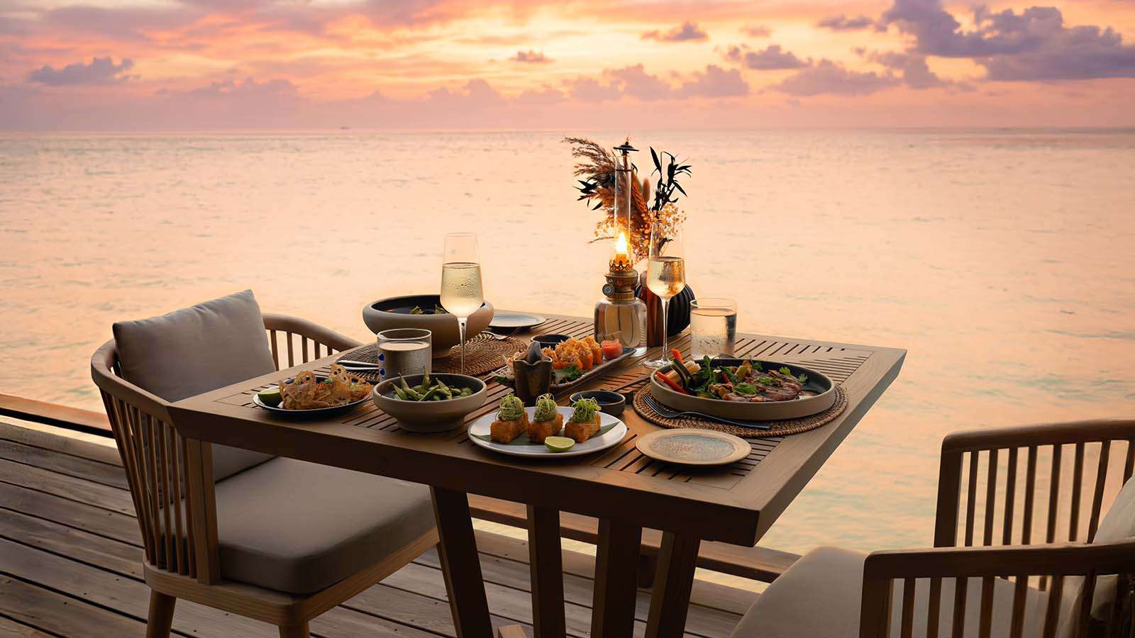 Dining set for two at sunset at Kumo Restaurant, Nala Maldives