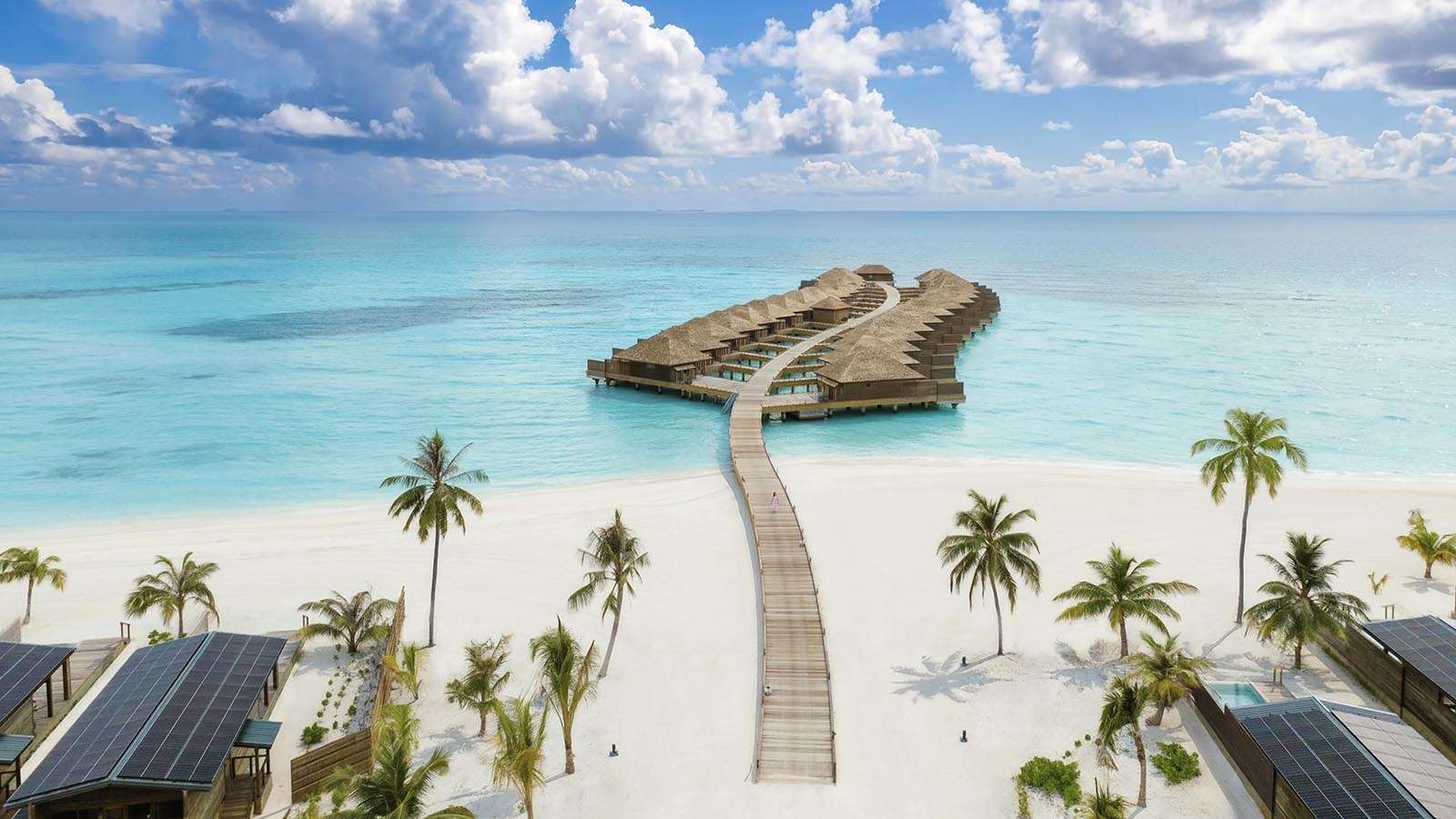 Ariel view of water villas beach and palm trees at Nala Maldives Island resort