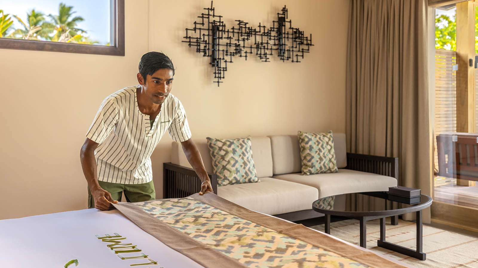 A man making a bed Nala Maldives Island resort